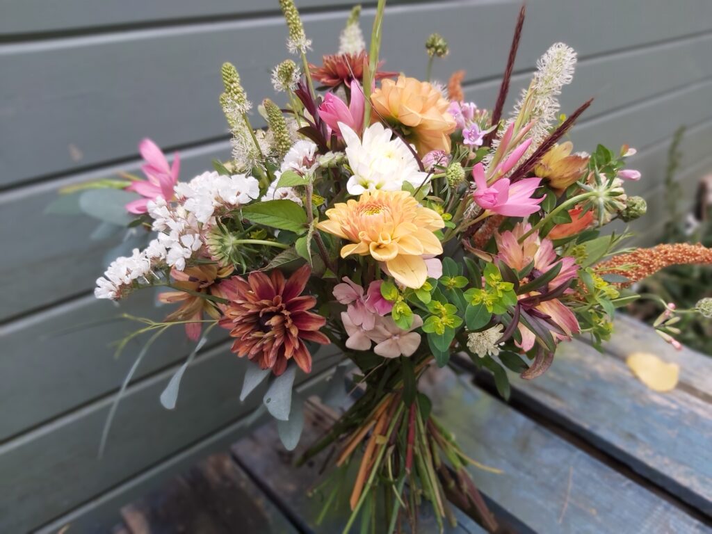 A late summer hand tie in autumnal shades with fluffy plumes of grass