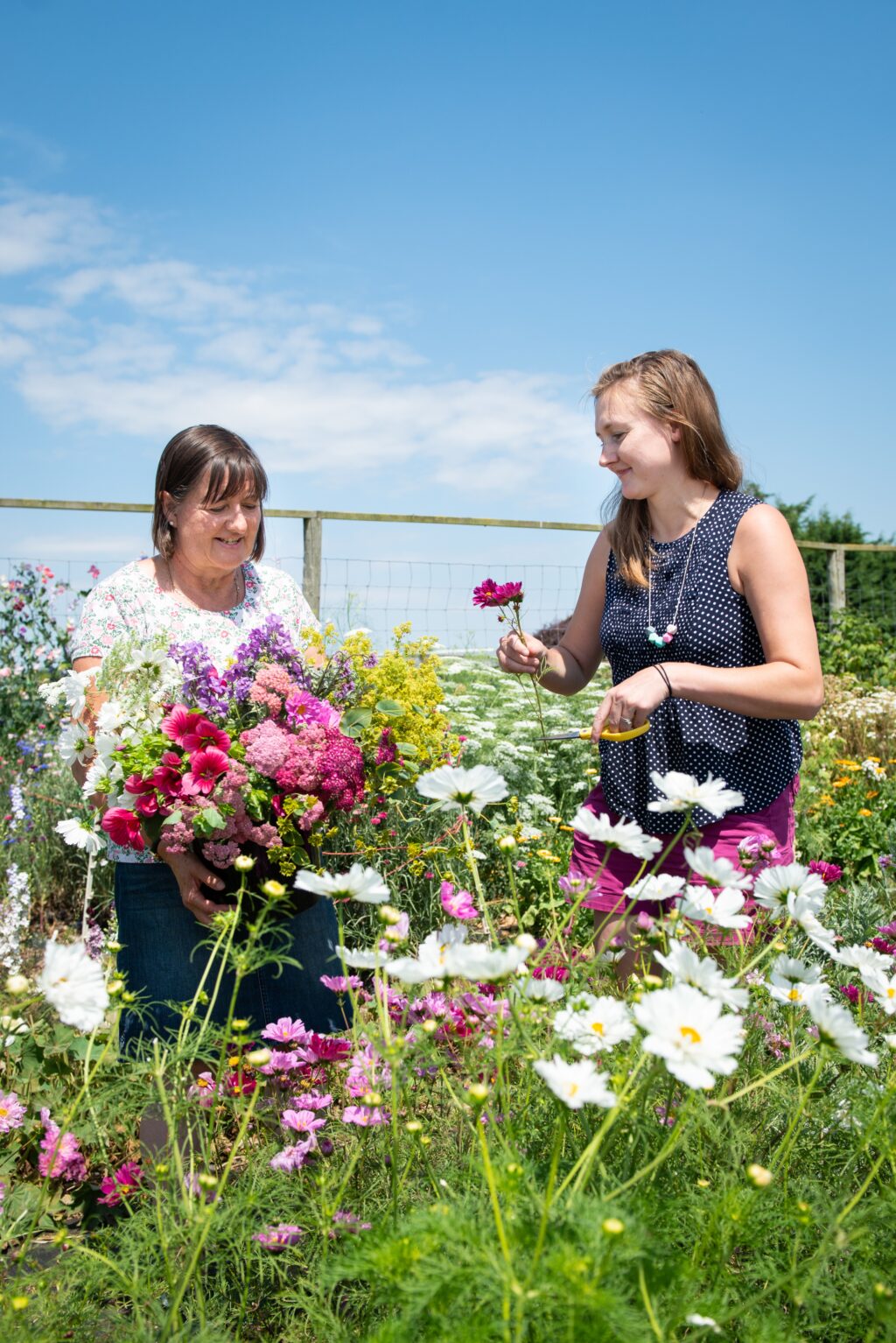 Charlotte and Jo of Little Paddock Flowers work in their flower field.