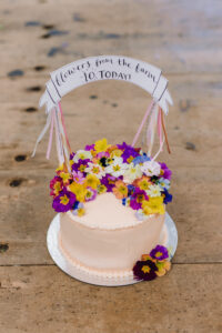 A 10th birthday cake for Flowers from the Farm, decorated with edible flowers by Tallulah Rose Flower School. The edible flowers are primulas from Maddocks Organics.