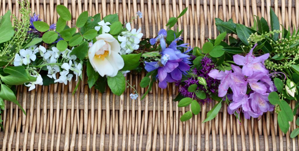 A June garland with roses, rhodedendrons and anemones. Tuckshop Flower