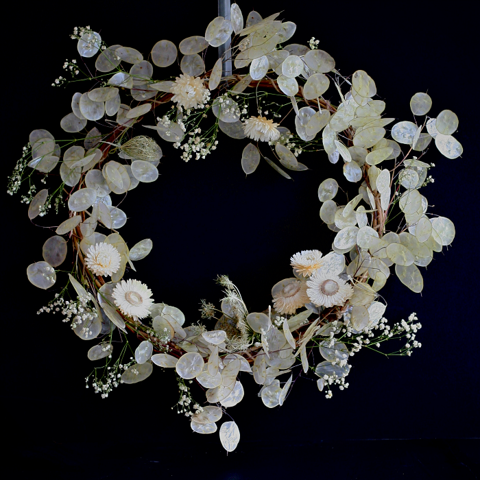 A white winter dried flower wreath by Henthorn Farm Flowers Lancashire with white honesty, helichrysum and gypsophila.