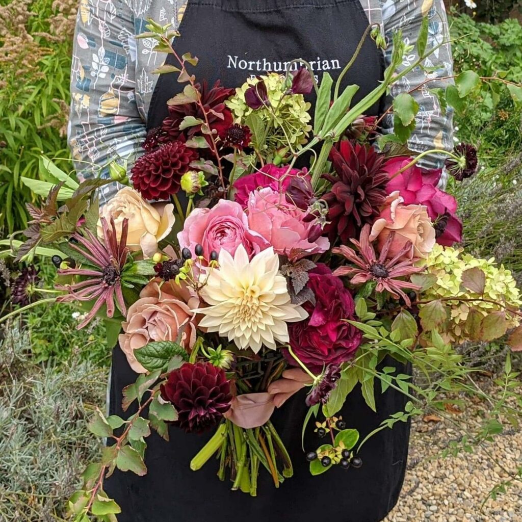 Northumbrian Flowers Kate holds an autumn bouquet of dahlias, roses and rudbeckias.