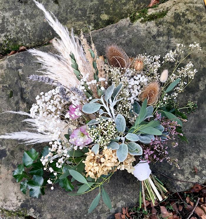 A winter bouquet made with a combination of fresh silvery foliages and dried plumes of pampas grass, teasels, dried lavender, gypsophila and hydrangea.