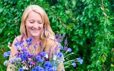 Charlotte of Elworthy Flowers holds a bright bunch of locally grown cornflowers to celebrate British Flowers Week June 2021