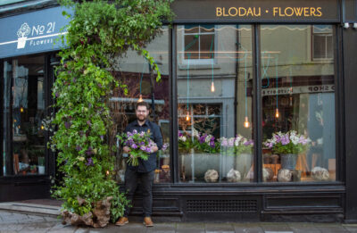 Alex of Number21 Flowers decorates his shop window with British flowers in celebration of British Flowers Week 2021. Photo: Naomi Campbell Photography