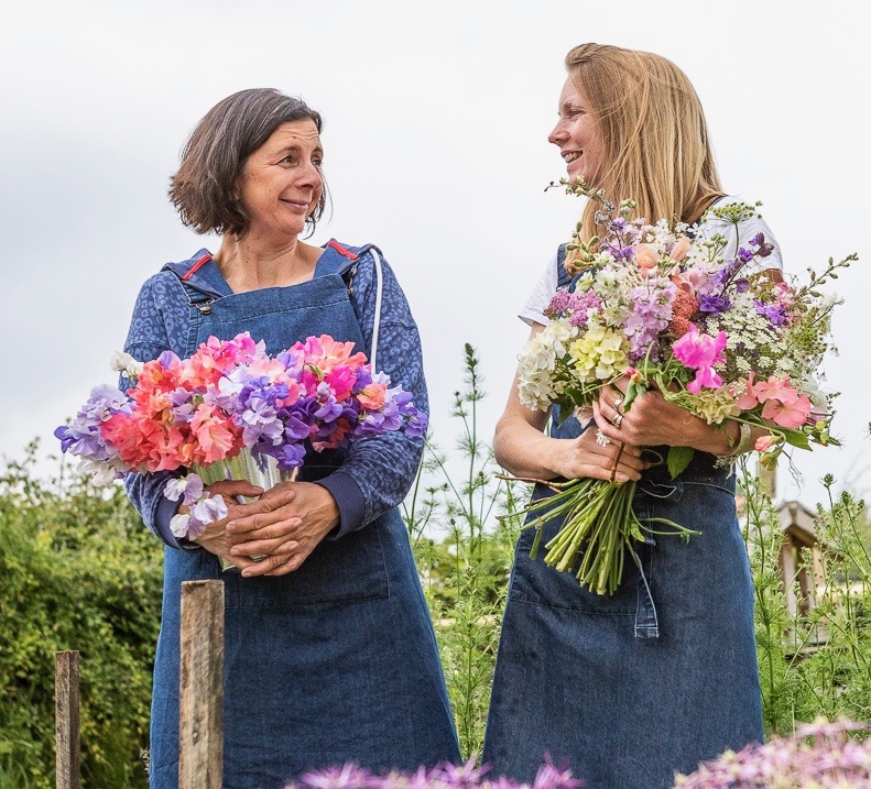 Jo and Lucy of Wye Valley Flowers holding bunches of their locally grown British flowers