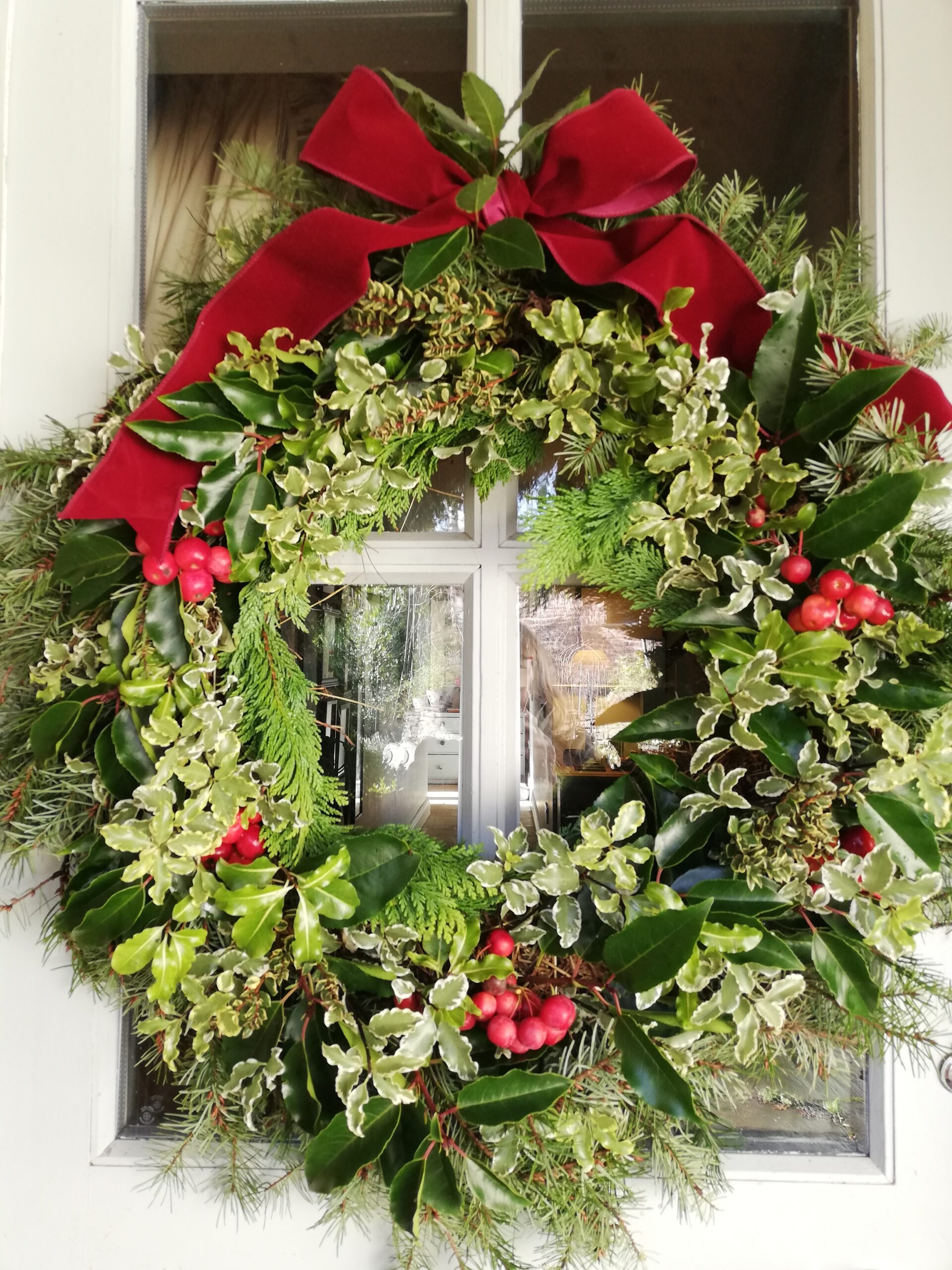 Rich reds and greens give a classic look to this festive wreath by Justine Scouller