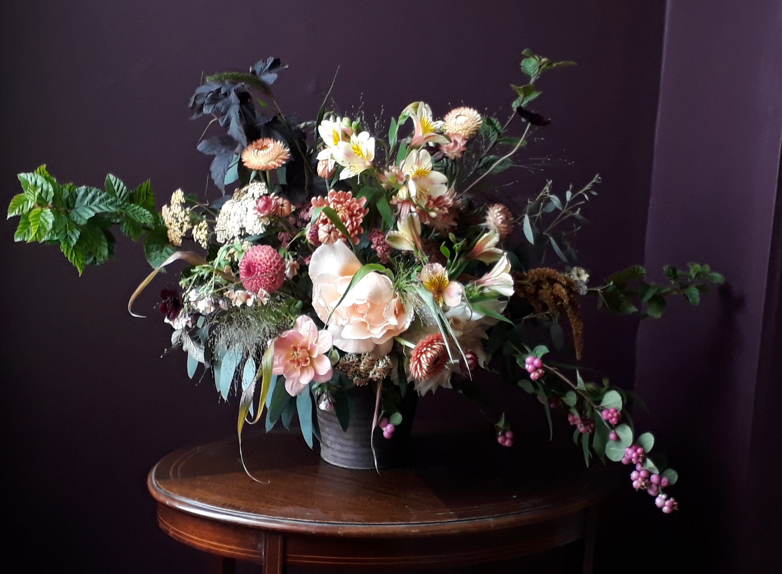A spring vase arrangment with British double narcissi and freshly cut foliage by The Crafty Gardeners