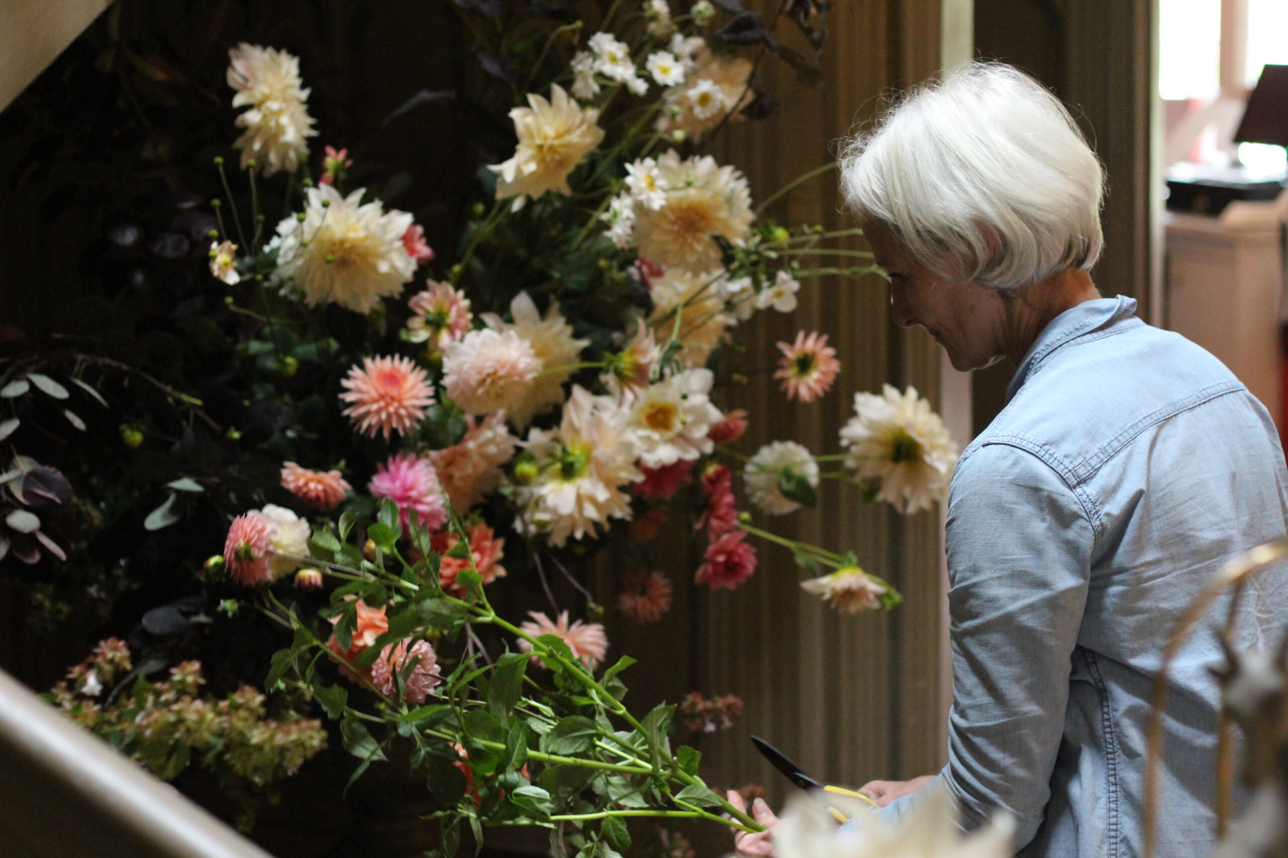 Leigh Chappell putting the finishing touches to her installation at the 2021 Strawberry Hill flower festival