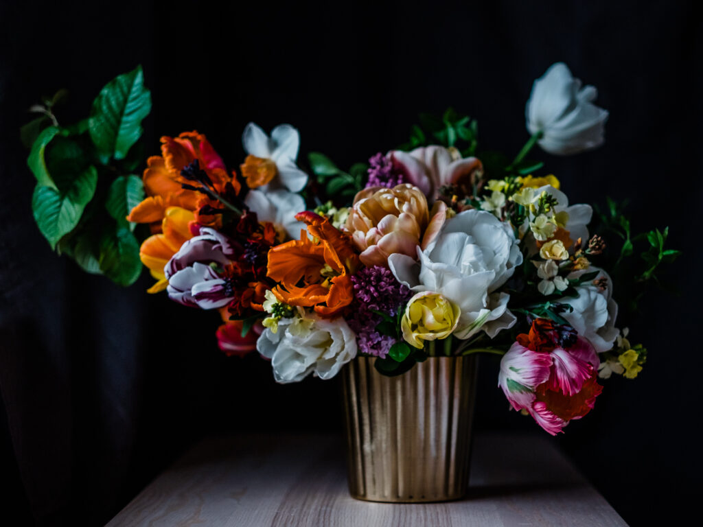 A colourful spring arrangement of brightly coloured tulips, daffodils and wallflowers