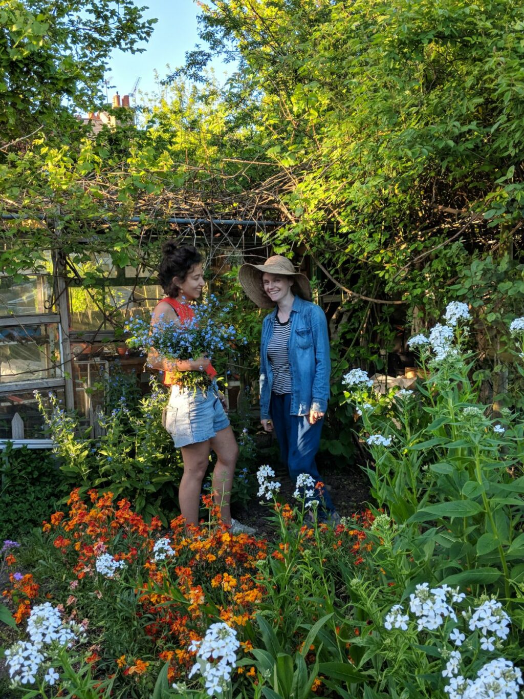 Camila and Marianne pictures in their flower garden at Wolves Lane, London