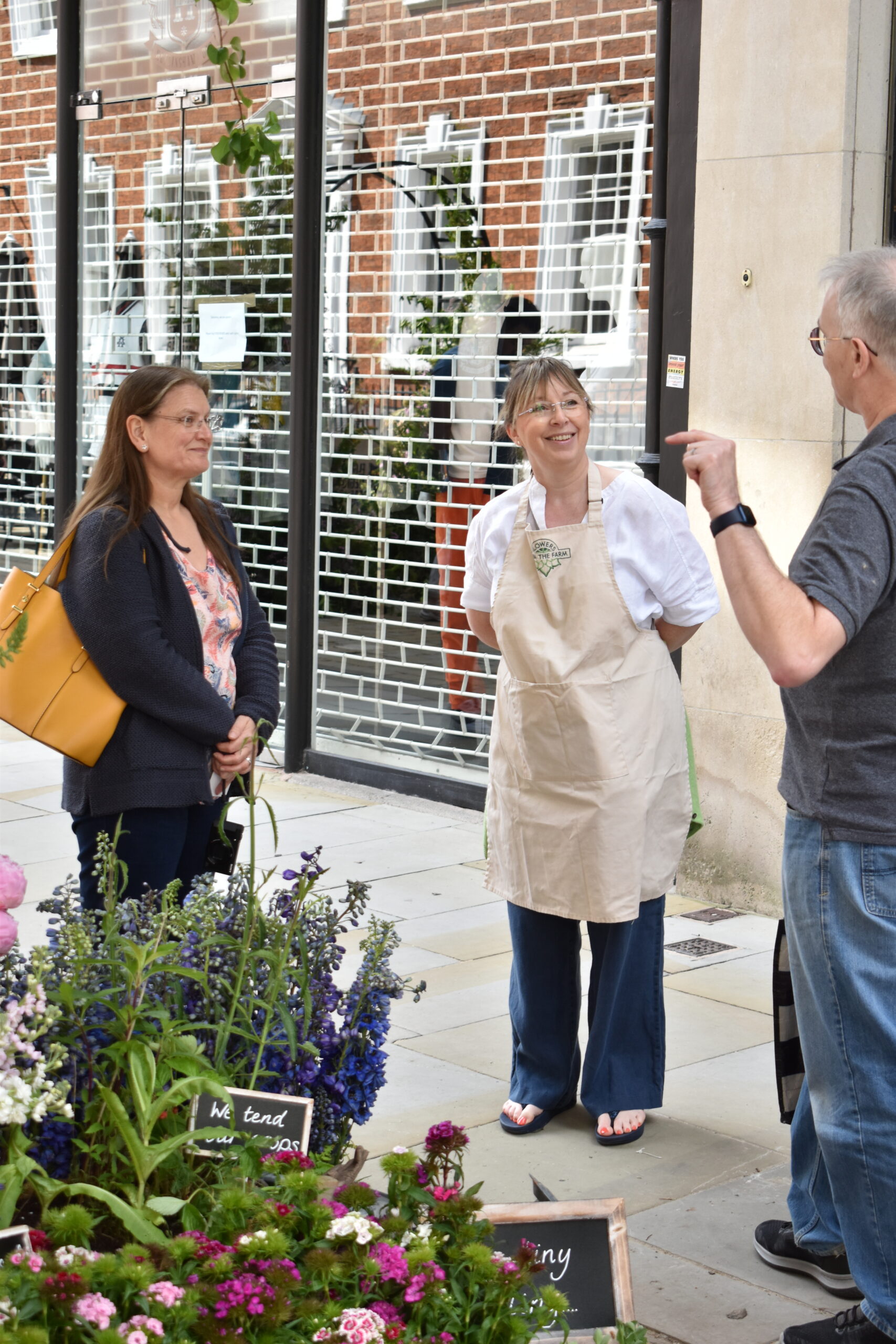 Visitors to the Flowers from the Farm stand at the Manchester Flower Show chatting to one of our members