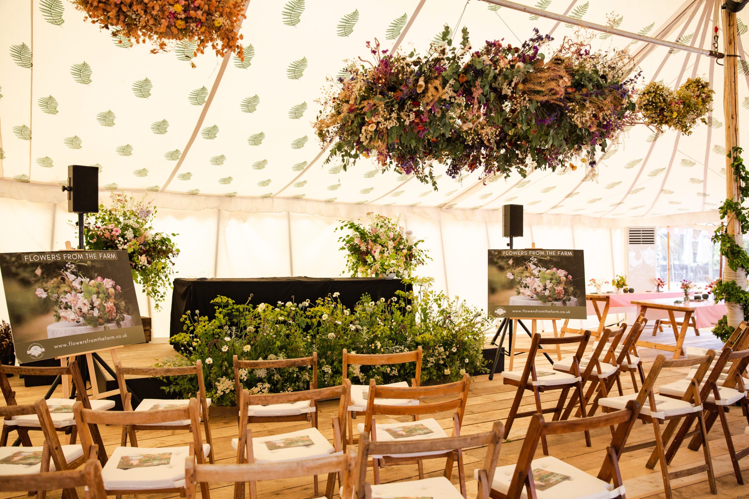 The stage at the RHS Flower School at Hampton Court bedecked with floral installations created from seasonal British flowers by FFTF members