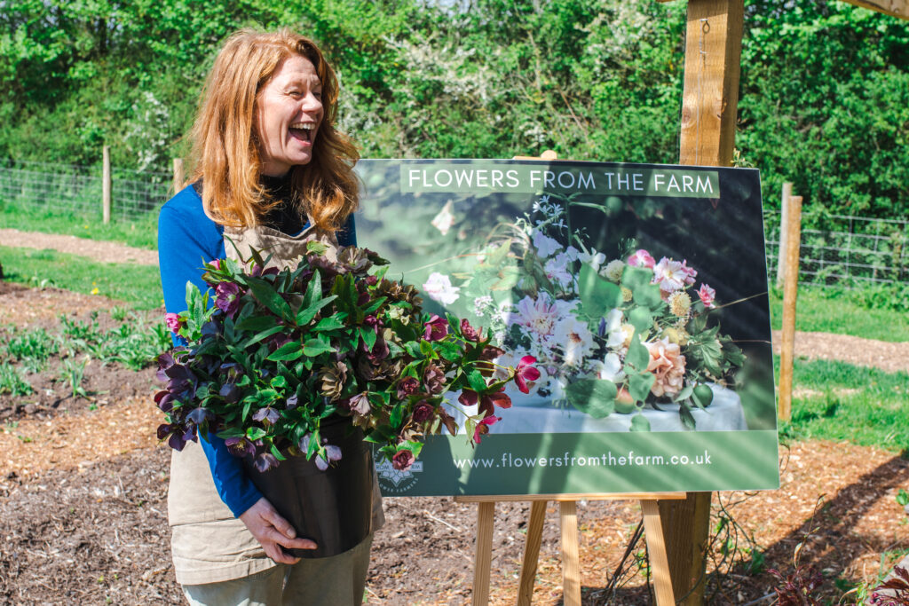 FFTF co-chair Debbie Scott of East Lothian Flowers laughs as she holds a bucket of hellebore flowers destined for the coronation of King Charles III.