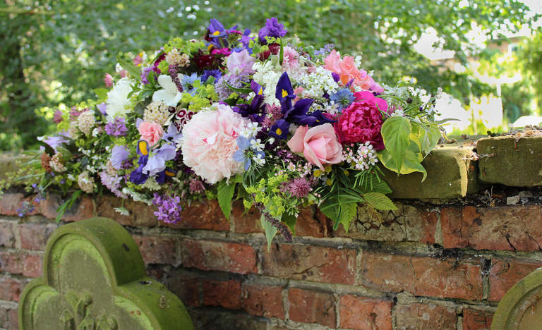 A pretty casket spray which can be separated into bouquets and shared. By Durham Blooms and Kiddal Quarry Flowers.