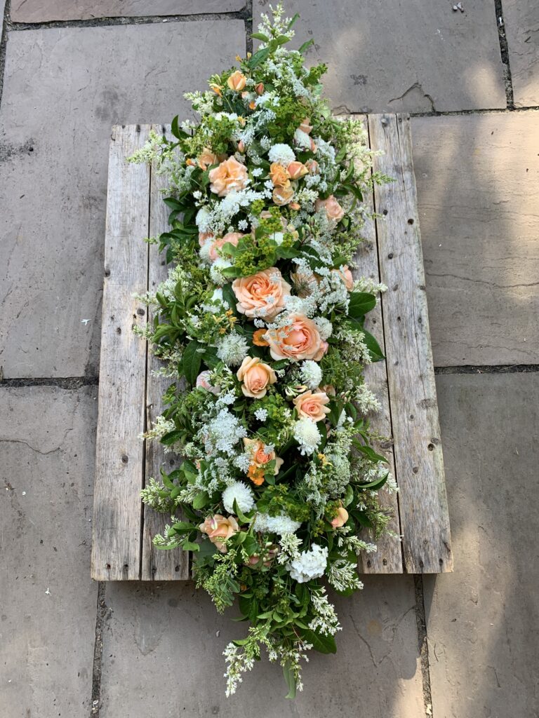 A scented summer rose casket spray by The Posy Patch, Derby.