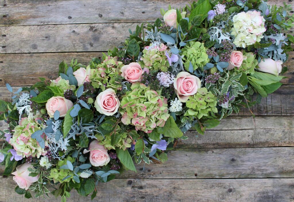 The Posy Patch funeral casket spray with hydrangeas and roses